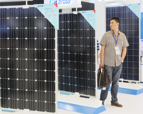 Solar panels on display at a solar and photovoltaic industry show in Shanghai on Tuesday. China has launched anti-dumping and anti-subsidy investigations into solar-grade polysilicon, an ingredient in solar panels, imported from the United States. 