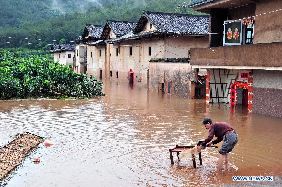 A villager cleans furniture in Baokeng Village of Meixian County in south China's Guangdong Province, May 19, 2013. 
