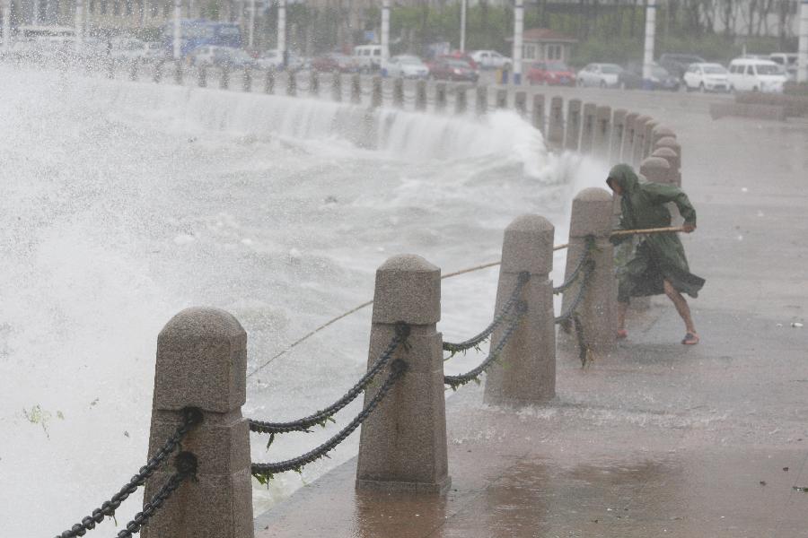 A fisherman catches floats against the storm by a seaside in Yantai City, east China's Shandong Province, May 27, 2013. A fisherman catches floats against the storm by a seaside in Yantai City, east China's Shandong Province, May 27, 2013.