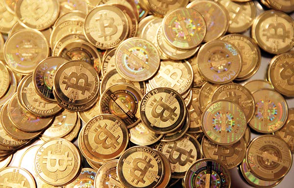 A pile of newly minted bitcoins arranged for a photograph in Sandy, Utah, in the United States. Created four years ago by a person or group using the name Satoshi Nakamoto, bitcoins are a virtual currency that can be used to buy and sell a broad range of items - from cupcakes to electronics. People can also pay with bitcoins in various coffee shops, phone and computer stores and bookstores in big Chinese cities including Beijing and Shanghai.