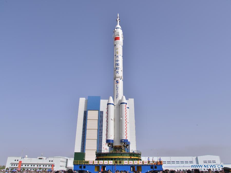 Photo taken on June 3, 2013 shows the assembly of the Shenzhou-10 spacecraft and the Long March-2F carrier rocket at Jiuquan Satellite Launch Center in Jiuquan, northwest China's Gansu Province.