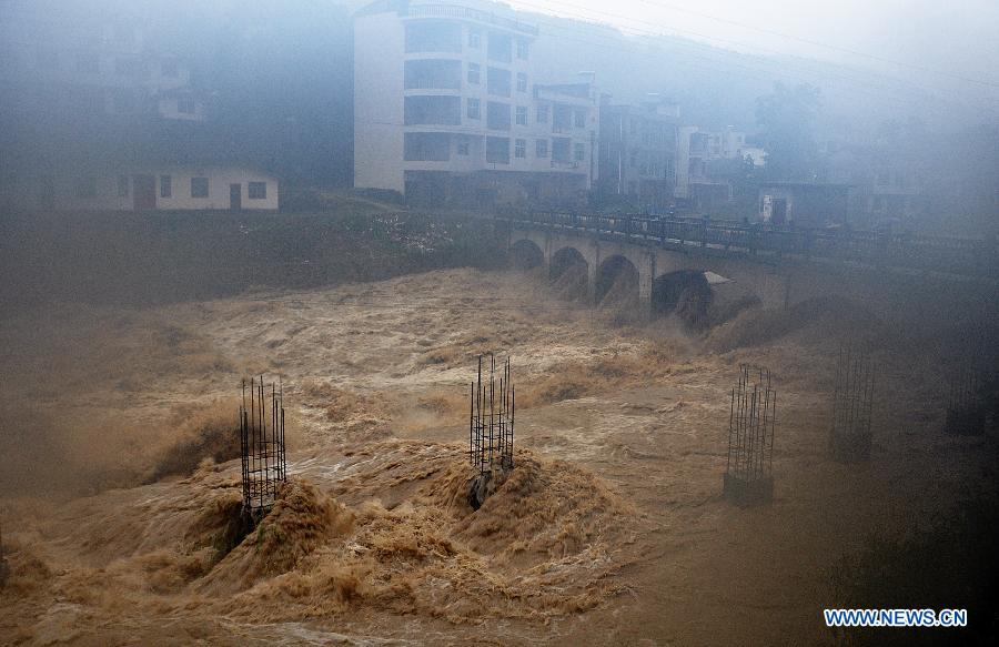 A building site is flooded in Gaoluo Township, Xuan'en County, Enshi Tujia and Miao Autonomous Prefecture of central China's Hubei Province, June 6, 2013. 