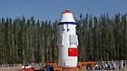 The Shenzhou 10 spacecraft, atop its Long March-2F carrier rocket booster, has been vertically transferred from a preparation area to the launch pad at the Jiuquan Satellite Launch Center in the Gobi desert.
