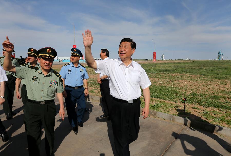 Chinese President Xi Jinping(R), also general secretary of the Central Committee of the Communist Party of China (CPC) and chairman of the Central Military Commission (CMC), shakes hands with those participating in the program of Shenzhou-10 manned spacecraft and sending his warm greetings to them at the Jiuquan Satellite Launch Center in Jiuquan, northwest China's Gansu Province, June 11, 2013.