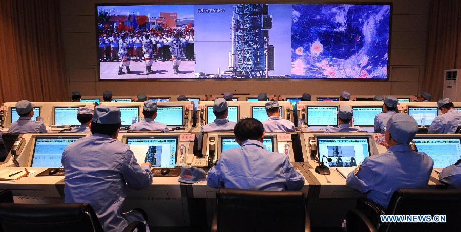 Technicians trace and monitor Shenzhou-10 spacecraft at a control central located in Taiyuan, north China's Shanxi Province, June 11, 2013. 