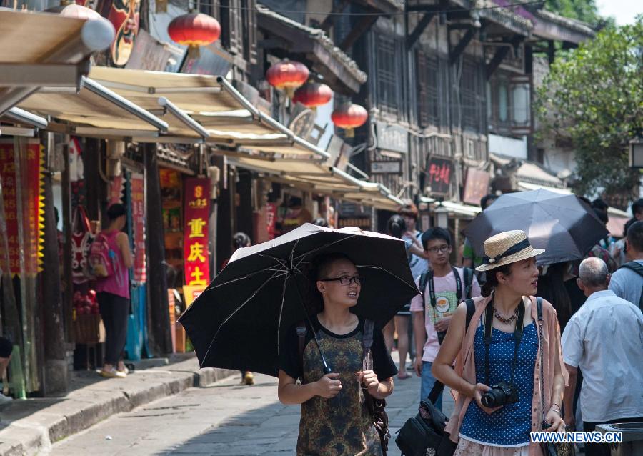 Tourists visit Ciqikou Town during a heat wave in Chongqing, southwest China's municipality, June 16, 2013.