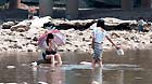 Girls cool themselves off in the Jialingjiang River at Ciqikou Town in Chongqing, southwest China's municipality, June 16, 2013.