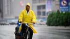 A citizen rides a bicycle in the rain in Yinchuan, capital of northwest China's Ningxia Hui Autonomous Region, June 19, 2013.