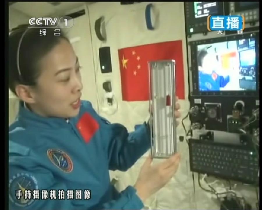 This TV grab taken on June 20, 2013 shows female astronaut Wang Yaping, one of the three crew members of Shenzhou-10 spacecraft, demonstrating pendulum movement in space during a lecture to students on Earth aboard China's space module Tiangong-1. This TV grab taken on June 20, 2013 shows female astronaut Wang Yaping, one of the three crew members of Shenzhou-10 spacecraft, demonstrating pendulum movement in space during a lecture to students on Earth aboard China's space module Tiangong-1.