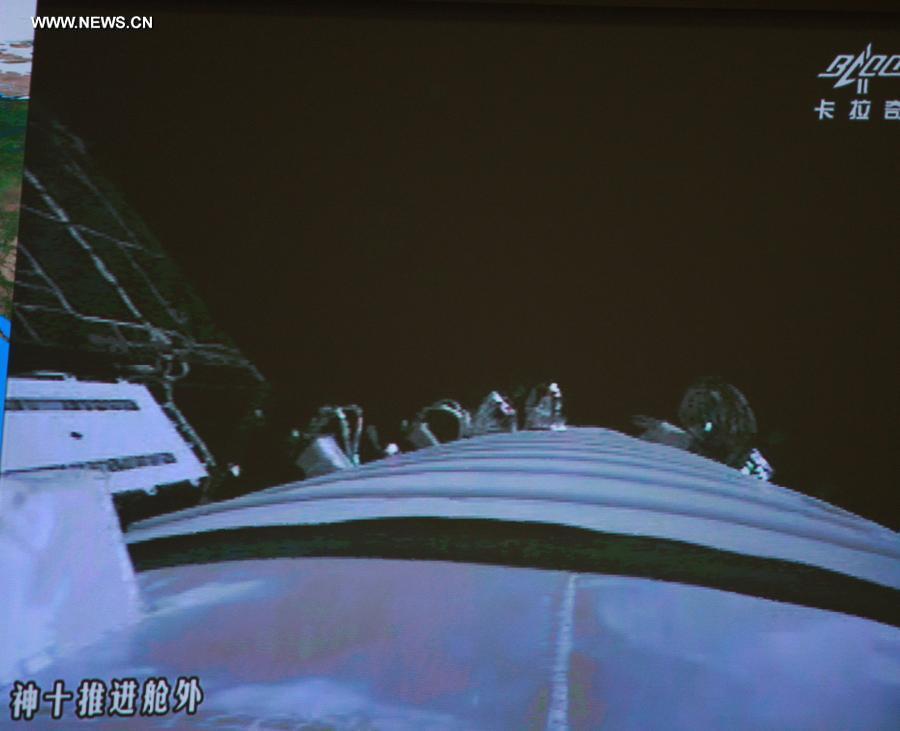 The screen at the Beijing Aerospace Control Center shows the scene outside the Shenzhou-10 spacecraft, June 26, 2013. 
