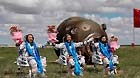 Astronauts Zhang Xiaoguang, Nie Haisheng and Wang Yaping (from left to right) greet the people after getting out of the re-entry capsule of China's Shenzhou-10 spacecraft following its successful landing at the main landing site in north China's Inner Mongolia Autonomous Region on June 26, 2013.