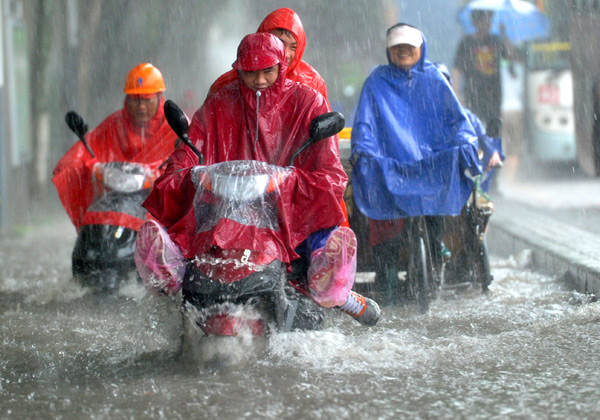 Traveling proves tough during a downpour in Nanjing, capital of Jiangsu Province, on Tuesday, as East China is swept by heavy rain.