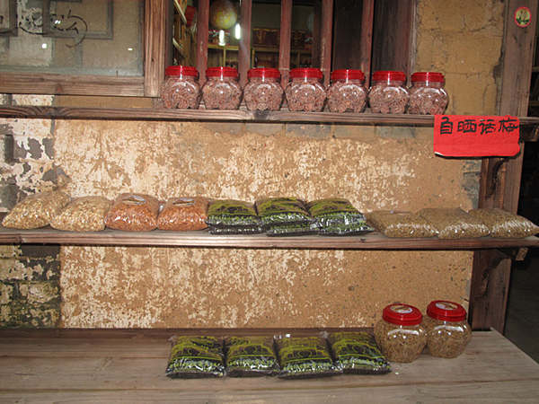 Plum candy and other snacks made by locals for sale. [CnDG by Jiao Meng]