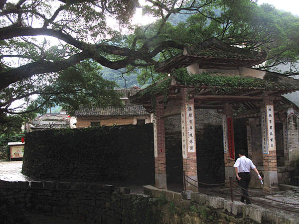 A tourist walks along the stone street. [CnDG by Jiao Meng]