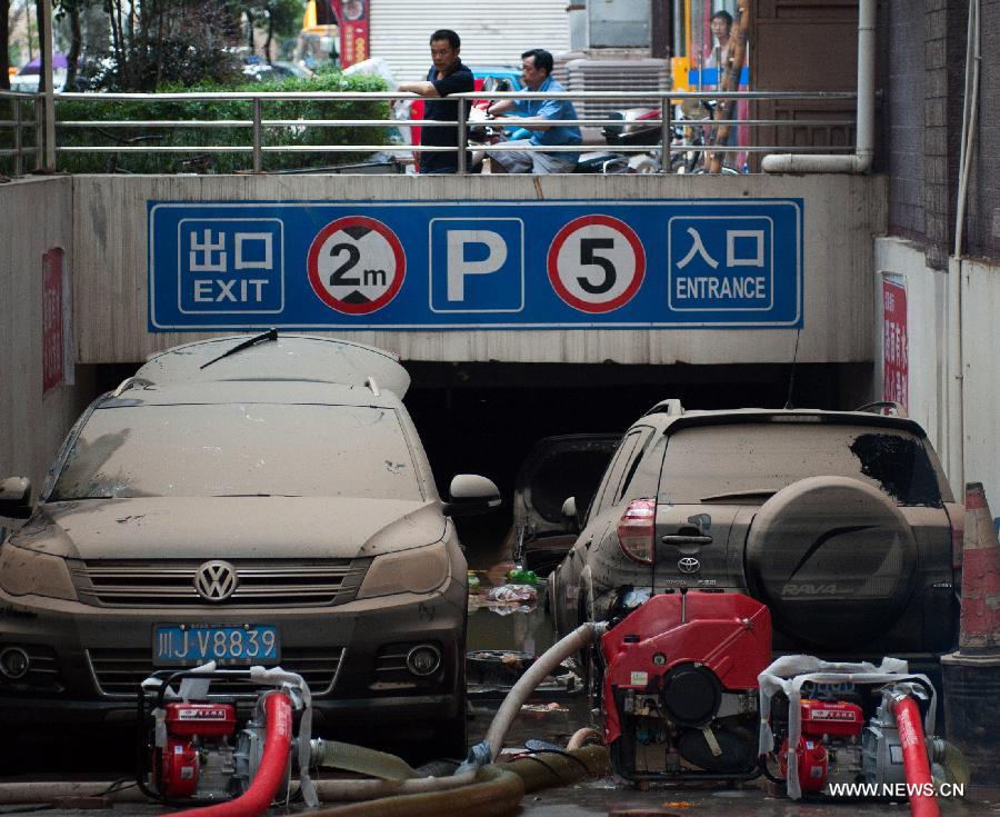Vehivles park at the entrance to a flooded underground parking lot in Suining, southwest China&apos;s Sichuan Province, July 2, 2013. 