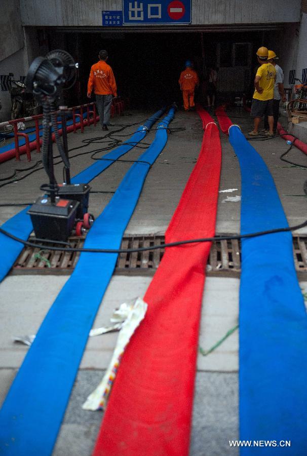 People pump water from a flooded underground parking lot in Suining, southwest China's Sichuan Province, July 2, 2013. People pump water from a flooded underground parking lot in Suining, southwest China's Sichuan Province, July 2, 2013.