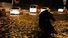 A citizen walks his or her electric bicycle on a waterlogged road in Tianjin, north China, July 4, 2013.