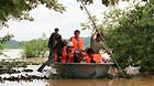 Rescuers row a boat heading for the flooded Hebei Village, Qingyang County, east China's Anhui Province, July 6, 2013.
