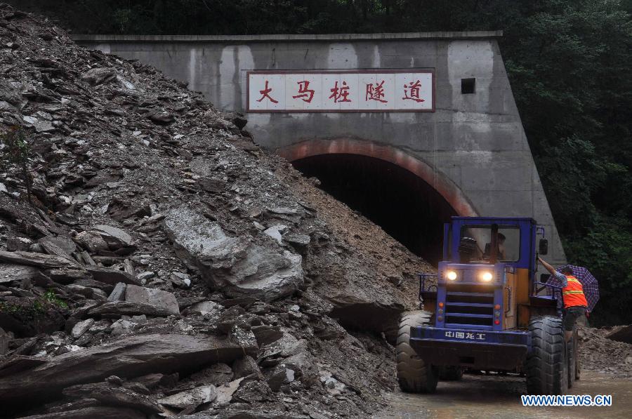 Rescuers open up landslide-blocked Damazhuang tunnel on 302 provincial road in Beichuan Qiang Autonomous County, southwest China's Sichuan Province, July 9, 2013.