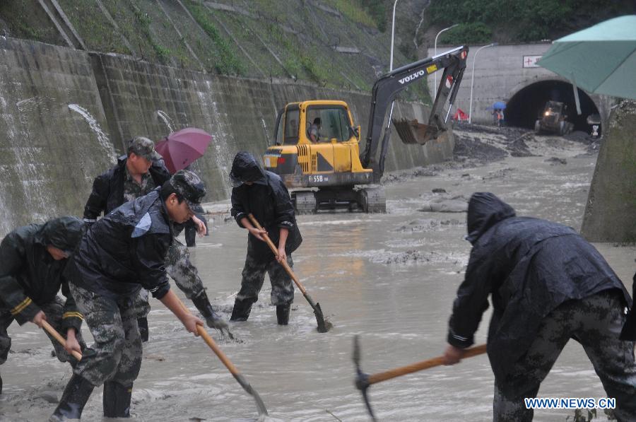 Rescuers open up flooded-road near Shilibei tunnel on 302 provincial road in Beichuan Qiang Autonomous County, southwest China's Sichuan Province, July 9, 2013. Rescuers open up flooded-road near Shilibei tunnel on 302 provincial road in Beichuan Qiang Autonomous County, southwest China's Sichuan Province, July 9, 2013.