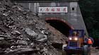 Rescuers open up landslide-blocked Damazhuang tunnel on 302 provincial road in Beichuan Qiang Autonomous County, southwest China's Sichuan Province, July 9, 2013.