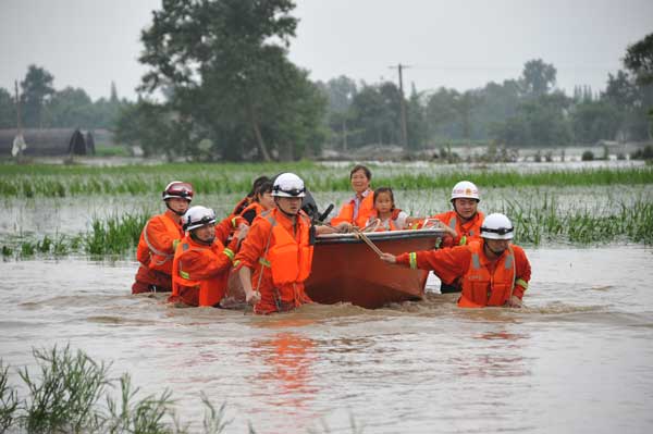 Rescuers race against time to evacuate people as floods continue to sweep through Guanghan, southwest China's Sichuan Province, on Thursday.