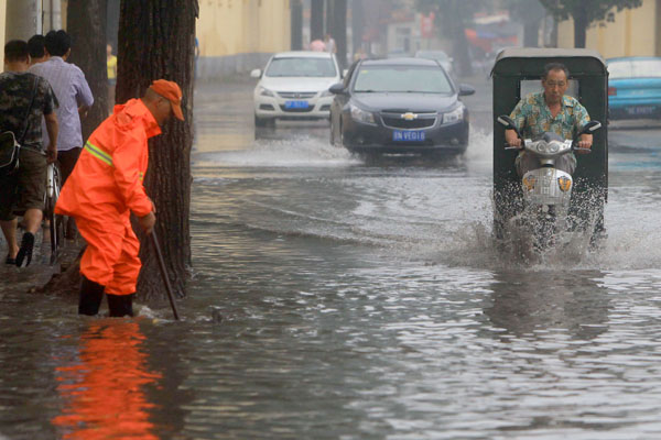 Beijing's streets are flooded after torrential rains on Sunday afternoon.