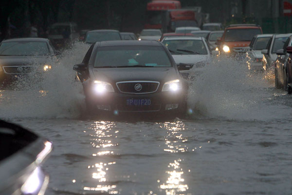 Beijing's streets are flooded after torrential rains on Sunday afternoon.