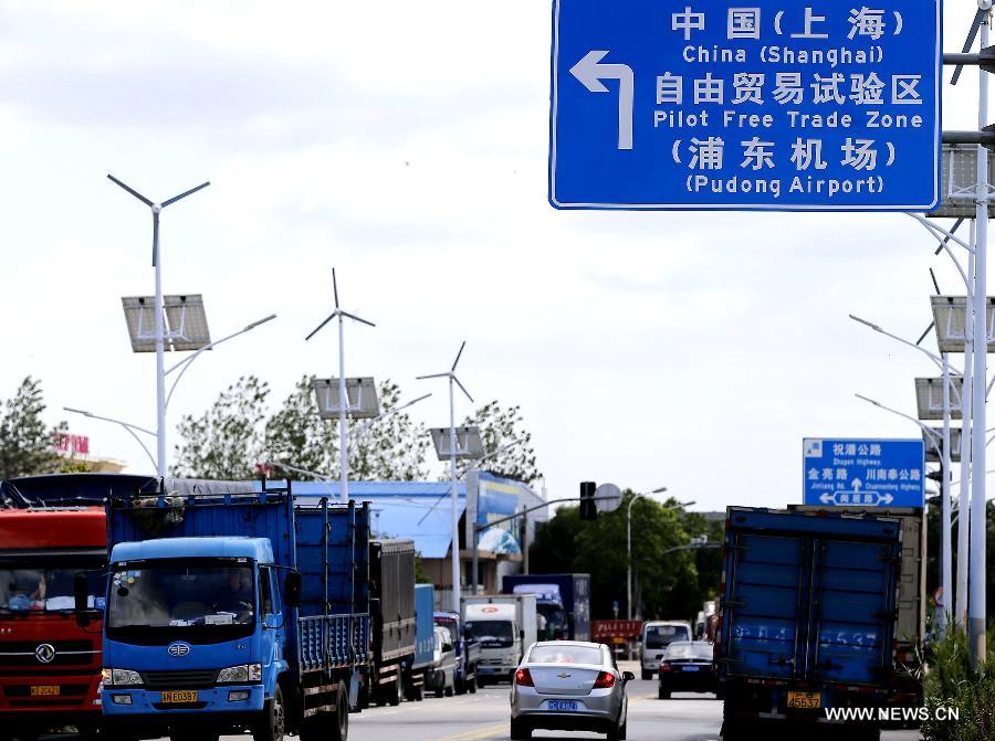 Vehicles are seen near the Pudong Airport Comprehensive Free Trade Zone, part of the free trade zone (FTZ) in Shanghai, east China, Sept. 25, 2013. 