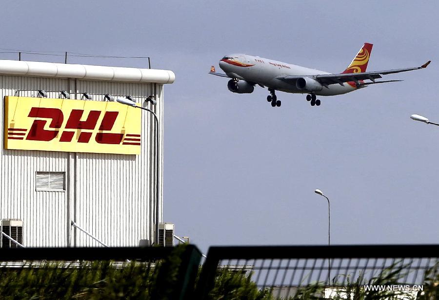 An airliner descends near the Pudong Airport Comprehensive Free Trade Zone, part of the free trade zone (FTZ) in Shanghai, east China, Sept. 25, 2013.