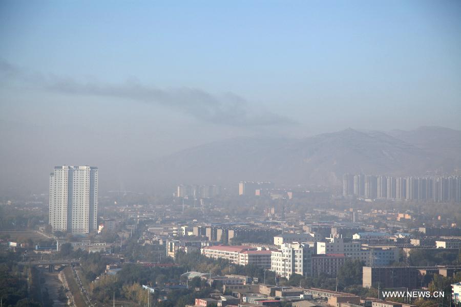 Xining, capital of northwest China&apos;s Qinghai Province is shrouded in haze, Oct. 9, 2013.