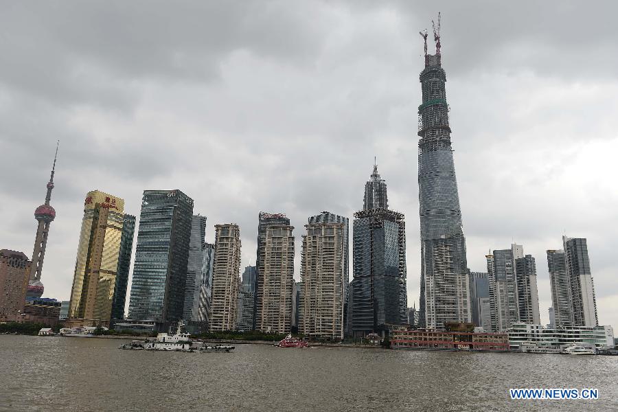 Photo taken on Oct. 15, 2013 shows the Shanghai Tower (the highest building in the center) which remains under construction in east China&apos;s Shanghai municipality. 