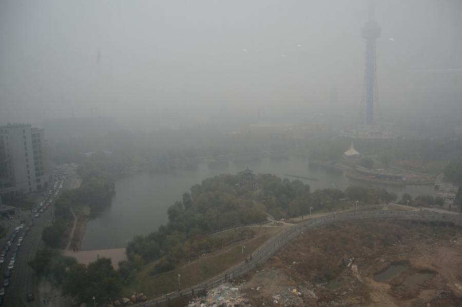 A tower appears through the fog in downtown Changchun, capital of northeast China&apos;s Jilin Province, Oct. 23, 2013. 