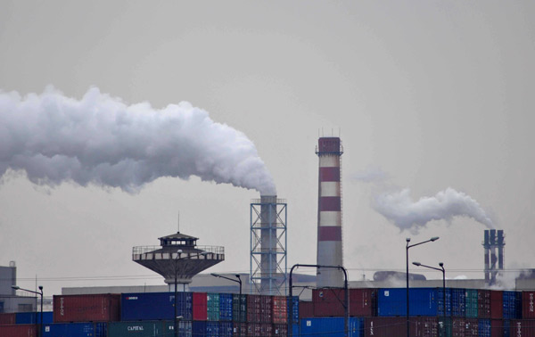 Smoke billows from a factory in Shanghai. China has made a commitment to the world to reduce energy consumption per unit of GDP by 16 percent by the end of 2015. 