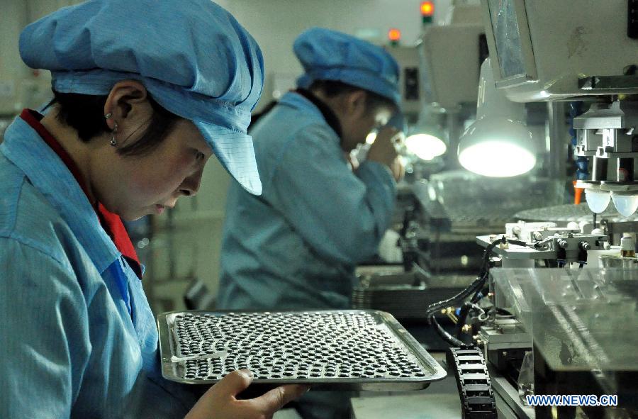 Workers check the newly produced contact lenses in a factory of the CST Automation Technology CO., LTD, a non-public enterprise, in Baiyin City, northwest China&apos;s Gansu Province, Oct. 31, 2013. 