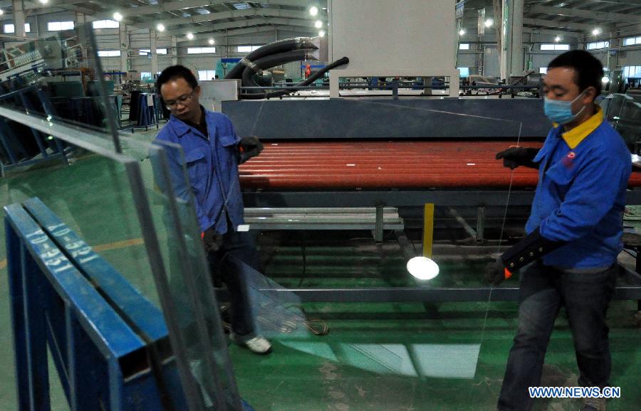  Workers produce the glass in an armored glass factory of a non-public enterprise, in Baiyin City, northwest China&apos;s Gansu Province, Oct. 31, 2013. 