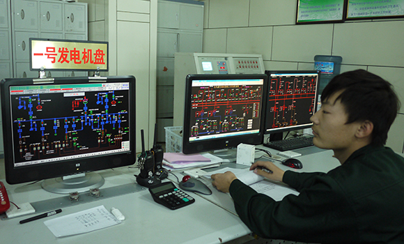 Worker is seen on duty at the control room of a biomass power plant in the company, Oct 20, 2013.