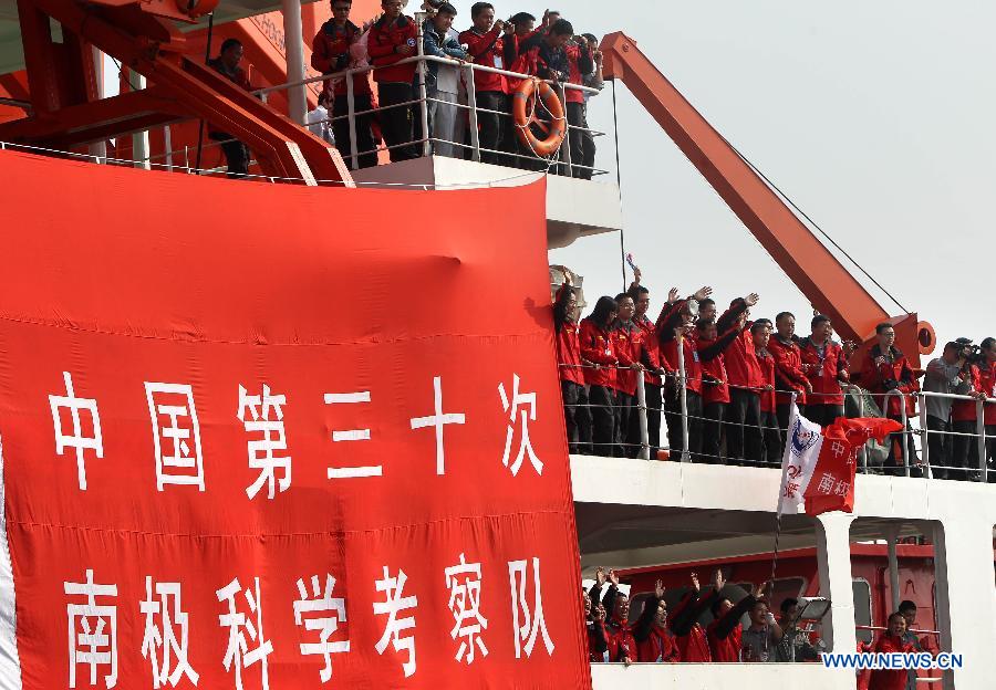 Members of the Chinese scientific expedition team members wave after boarding the research vessel and icebreaker Xuelong (Snow Dragon) in Shanghai, east China, Nov. 7, 2013.