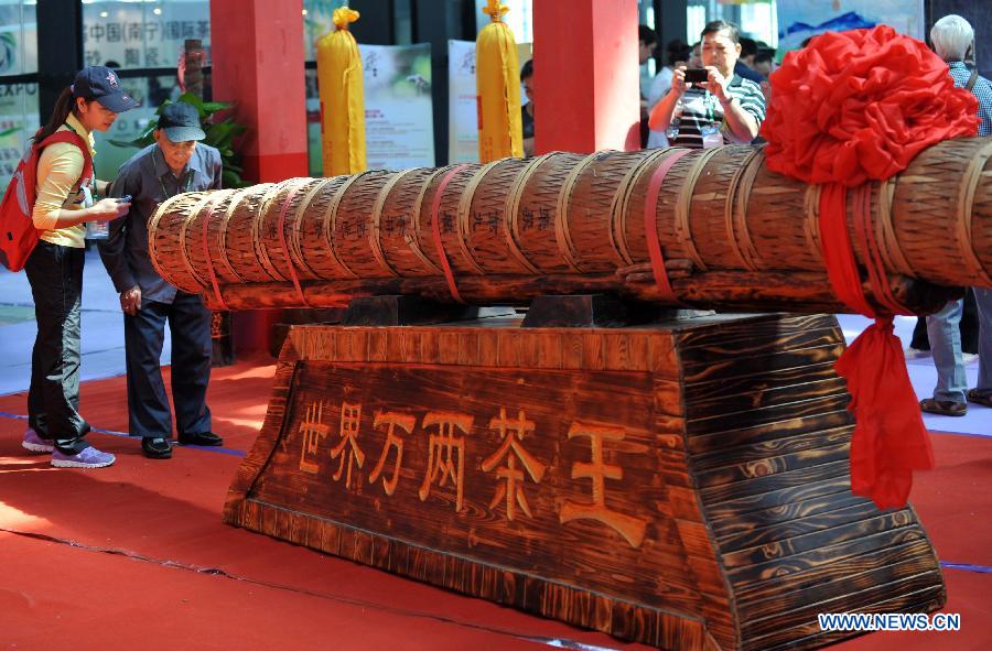 Visitors look at a giant tea stick during the 3rd China (Nanning) International Tea Expo in Nanning, capital of south China&apos;s Guangxi Zhuang Autonomous Region, Nov. 8, 2013.