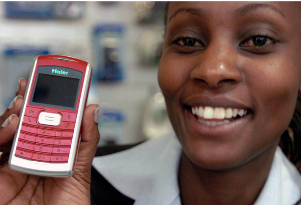 A sales assistant shows a cell phone made by Haier, a widely known Chinese brand, in Nairobi, Kenya, in 2005. More and more products with the “Made in China” label, from shoe polish to trucks, have become part of daily life in Africa.