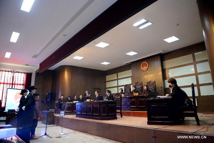 Zhang Shuxia, who is involved in a baby trafficking scandal, stands trial in Weinan Intermediate People's Court in Weinan, northwest China's Shaanxi Province, Dec. 30, 2013. Zhang was a doctor with the Fuping County Maternal and Child Health Care Hospital in the province and was detained by police in connection with trafficking of babies in August. (Xinhua/Li Yibo)