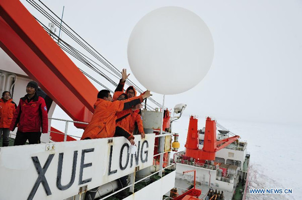 Members of Chinese Antarctic exploration team release the sounding balloon to forecast weather change, in Antarctica, Jan. 6, 2014.