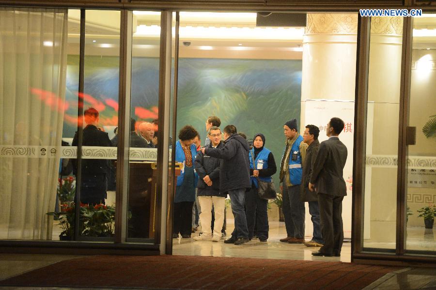 Staff members of Malaysia Airlines and volunteers accompanying relatives of passengers aboard the airlines' missing flight MH370 are seen at Terminal 3 of Capital International Airport in Beijing, capital of China, early March 11, 2014. Some of the relatives of passengers aboard the missing Malaysia Airlines flight MH370 left Beijing for Kuala Lumpur early on Tuesday.