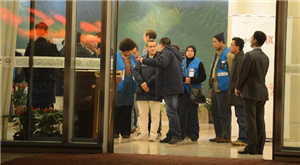 Staff members of Malaysia Airlines and volunteers accompanying relatives of passengers aboard the airlines' missing flight MH370 are seen at Terminal 3 of Capital International Airport in Beijing, capital of China, early March 11, 2014.