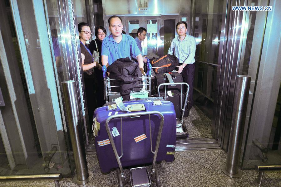 Memebers of Chinese joint working group in charge of the missing Malaysia Airlines flight incident arrives at the International Airport of Kuala Lumpur in Sepang, Malaysia, on March 10, 2014. 