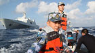 Rescuers aboard the Chinese naval vessel Jianggangshan take a boat to carry out search mission at the possible crash site of missing Malaysia Airlines flight MH370, March 13, 2014. As of 12 a.m. (0400 GMT) Thursday, Chinese search teams had searched 45,763 square kilometers, no solid clues were located.