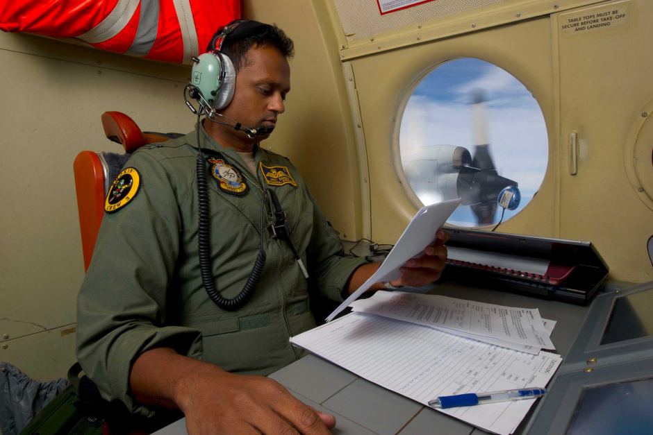 A Royal Australian Air Force tactical coordinator runs the search for flight MH370 in an AP-3C Orion.