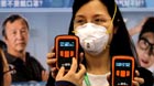 Portable PM2.5 attract visitors at an exhibition of air purifiers and anti-bacterial disinfectors at the National Agriculture Exhibition Center in Beijing on Monday, as heavy smog continues to shroud the capital.