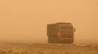 A truck runs in sand and dust in Urad Middle Banner of Bayan Nur, north China's Inner Mongolia Autonomous Region, April 24, 2014. A cold current hitting Inner Mongolia Autonomous Region swept sand and dust on Thursday.