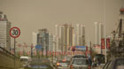 Vehicles run in dust in Xining, capital of northwest China's Qinghai Province, April 29, 2014. The capital city was shrouded by floating dust on Tuesday.